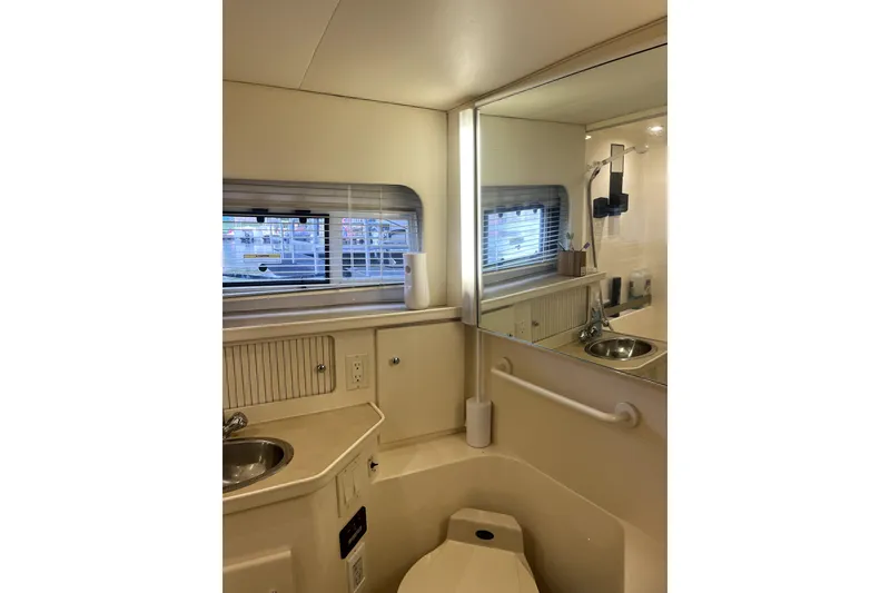 Slide: The Image of 1998 Carver 355 Aft Cabin bathroom with sink, mirror, and window. - 35