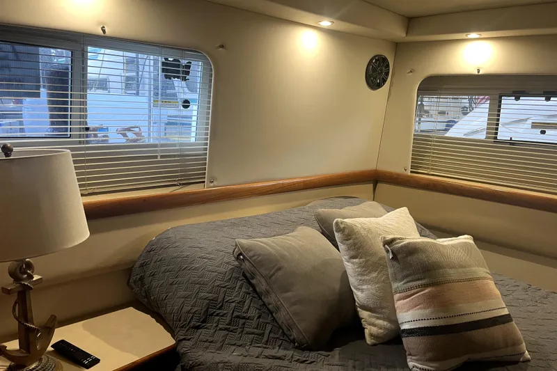 Slide: The Image of Cozy interior of 1998 Carver 355 Aft Cabin with bed, pillows, and lamp. - 37