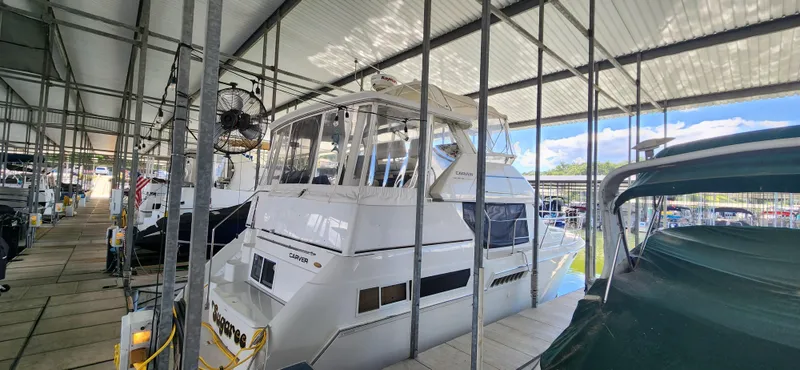 Slide: The Image of 1998 Carver 355 Aft Cabin Motor Yacht docked in a covered marina. - 4