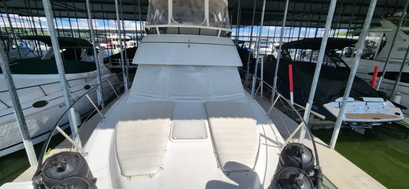 Slide: The Image of 1998 Carver 355 Aft Cabin Motor Yacht docked in a covered marina. - 7