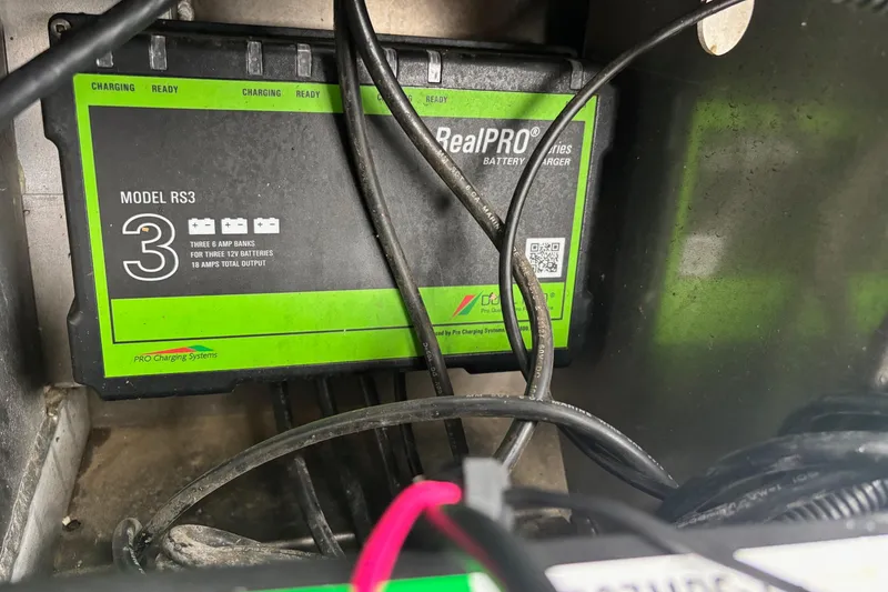Slide: The Image of Battery charger Model RS3 in a 2023 Ranger RT178 boat, with visible cables. - 13
