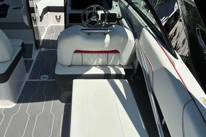 Slide: The Image of 2022 Regal LX2 boat interior with white seating and modern steering wheel design. - 12