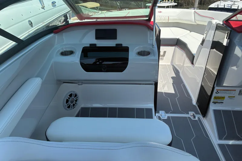 Slide: The Image of 2022 Regal LX2 boat interior with white seating, cup holders, and modern design. - 15
