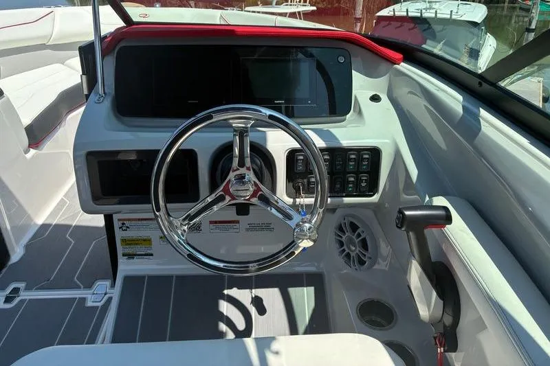 Slide: The Image of 2022 Regal LX2 boat dashboard with steering wheel and control panel. - 17