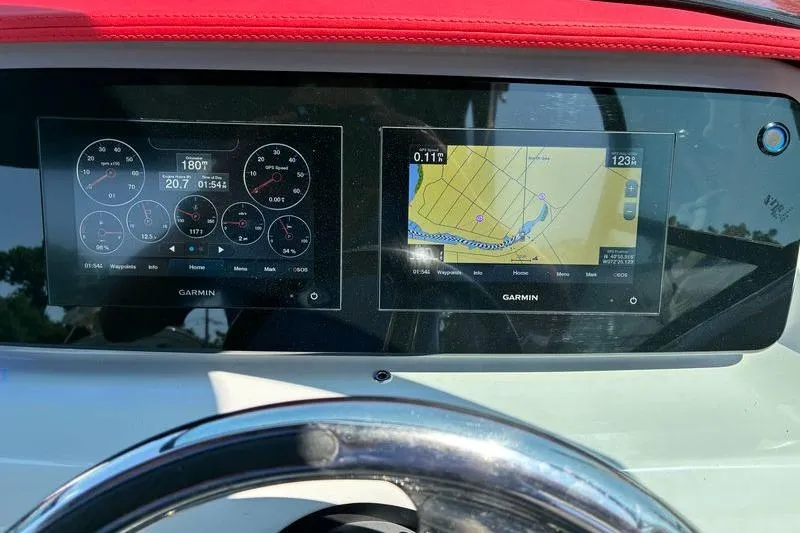 Slide: The Image of Dashboard of 2022 Regal LX2 boat with Garmin navigation displays. - 18