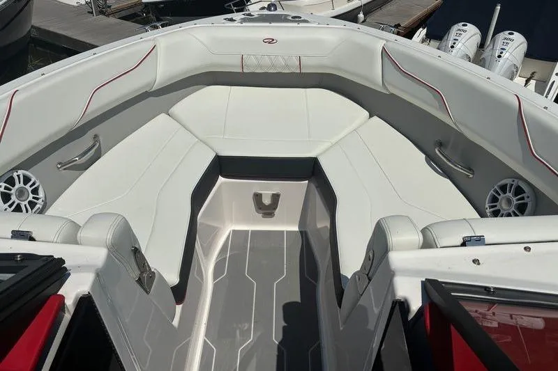 Slide: The Image of 2022 Regal LX2 boat interior with white seating and red accents. - 19