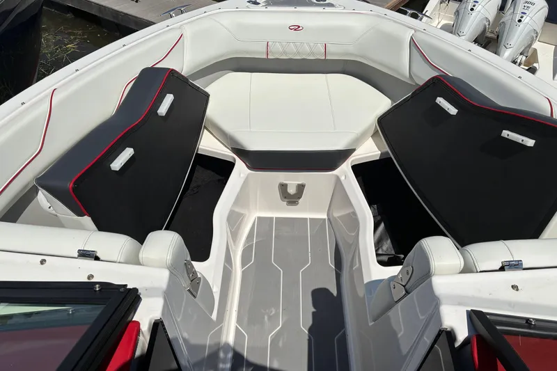 Slide: The Image of 2022 Regal LX2 boat interior with white and black seating, red accents. - 20