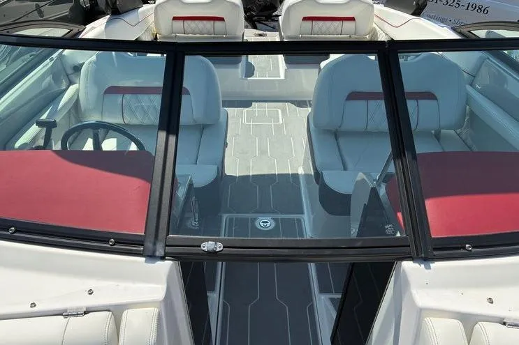 Slide: The Image of 2022 Regal LX2 boat interior with white and red seating, modern design. - 21