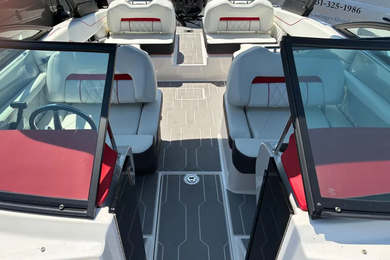 Slide: The Image of 2022 Regal LX2 boat interior with white and red seating, modern design. - 22