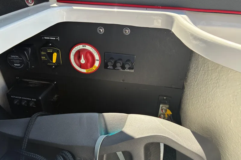 Slide: The Image of Control panel of a 2022 Regal LX2 boat with switches and battery controls. - 23