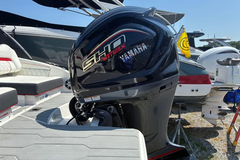 Slide: The Image of 2022 Regal LX2 boat with Yamaha SHO VMAX outboard motor at a marina. - 24
