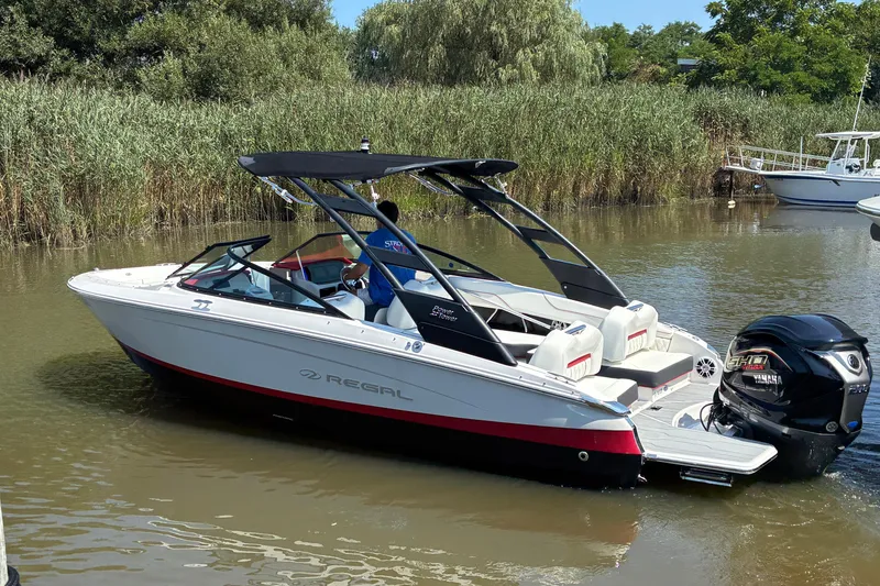 Slide: The Image of 2022 Regal LX2 boat with Yamaha engine on a calm river. - 5