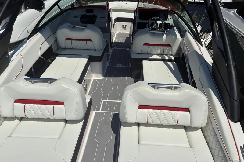 Slide: The Image of 2022 Regal LX2 boat interior with white and red seating, modern design. - 7