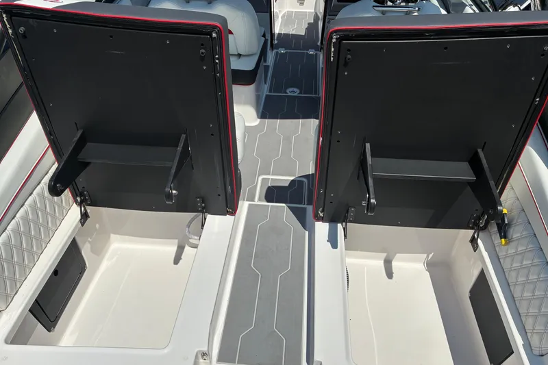 Slide: The Image of 2022 Regal LX2 boat interior with open storage compartments and cushioned seating. - 8