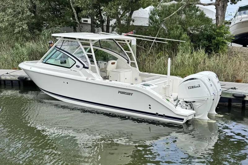 The Image of 2026 Pursuit DC 266 Dual Console boat docked with Yamaha engines. - 0