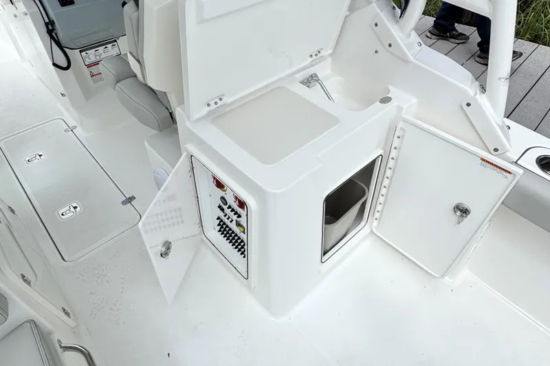 Slide: The Image of 2026 Pursuit DC 266 Dual Console boat interior with storage compartments and seating. - 11