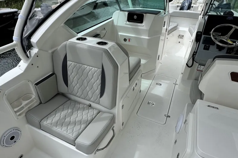 Slide: The Image of 2026 Pursuit DC 266 Dual Console interior with luxurious seating and modern design. - 12
