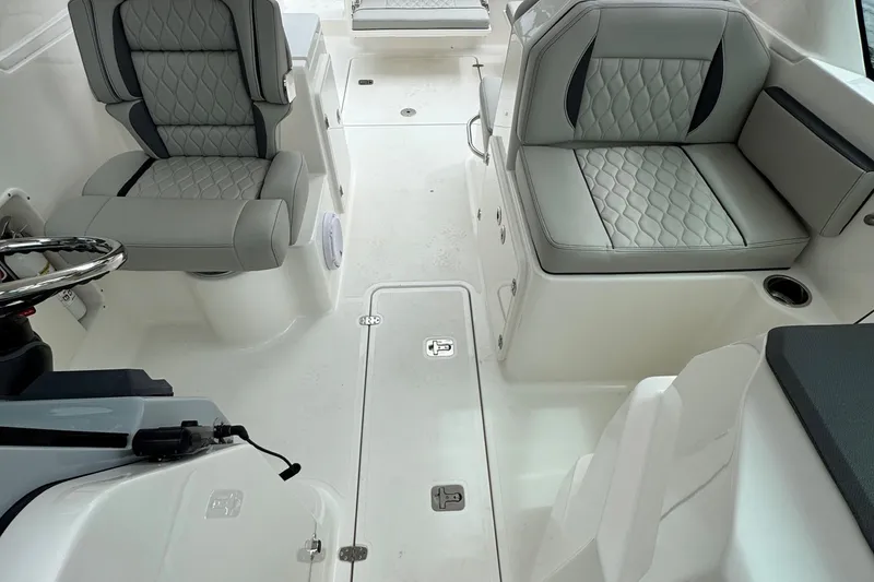 Slide: The Image of 2026 Pursuit DC 266 Dual Console interior with gray seating and modern design. - 13