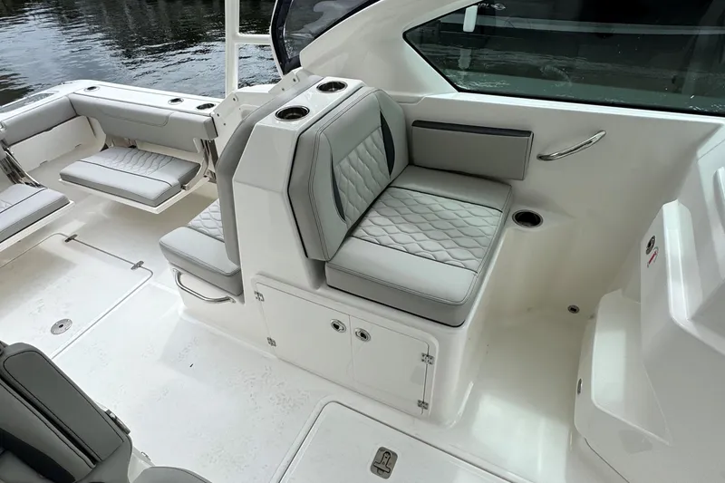 Slide: The Image of 2026 Pursuit DC 266 Dual Console boat interior with luxurious seating and modern design. - 14