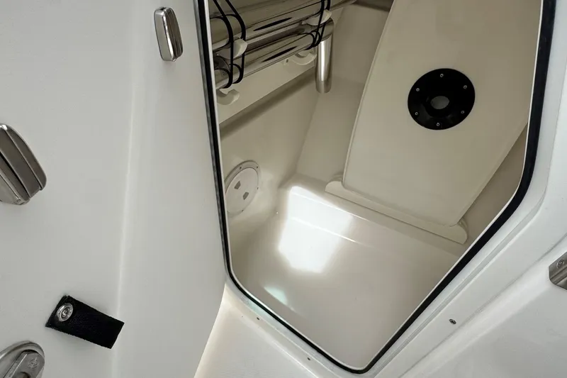 Slide: The Image of Interior view of 2026 Pursuit DC 266 Dual Console boat storage compartment. - 18