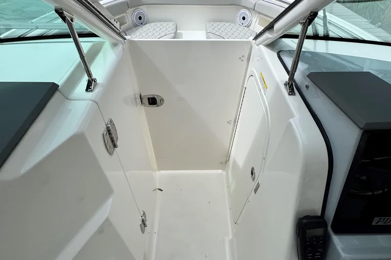 Slide: The Image of 2026 Pursuit DC 266 Dual Console interior with white seating and modern design. - 19