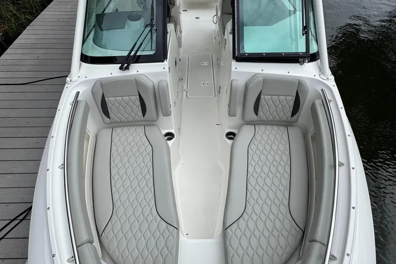 Slide: The Image of 2026 Pursuit DC 266 Dual Console boat with luxurious seating and sleek design. - 23