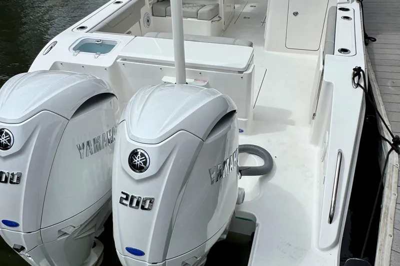 Slide: The Image of 2026 Pursuit DC 266 Dual Console boat with twin Yamaha 200 engines docked. - 3