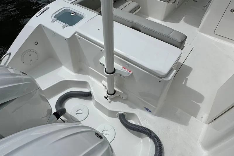 Slide: The Image of 2026 Pursuit DC 266 Dual Console boat interior with seating and engine area. - 4