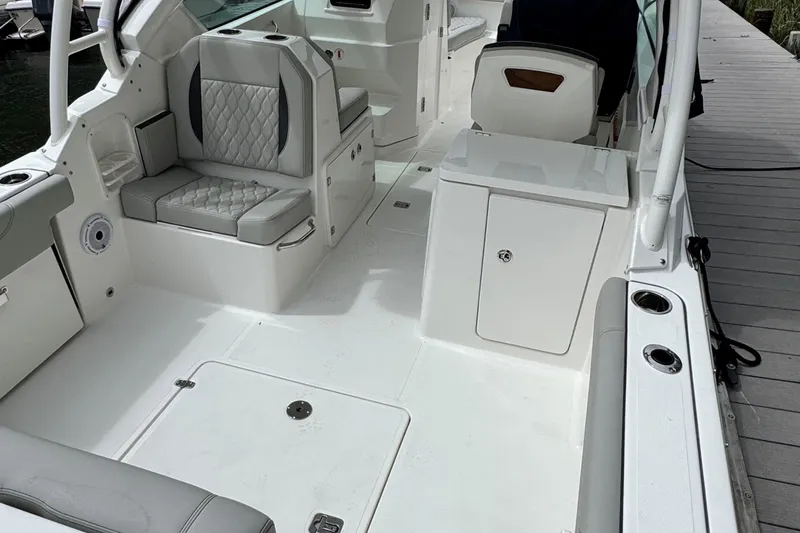 Slide: The Image of 2026 Pursuit DC 266 Dual Console boat interior with seating and storage compartments. - 5