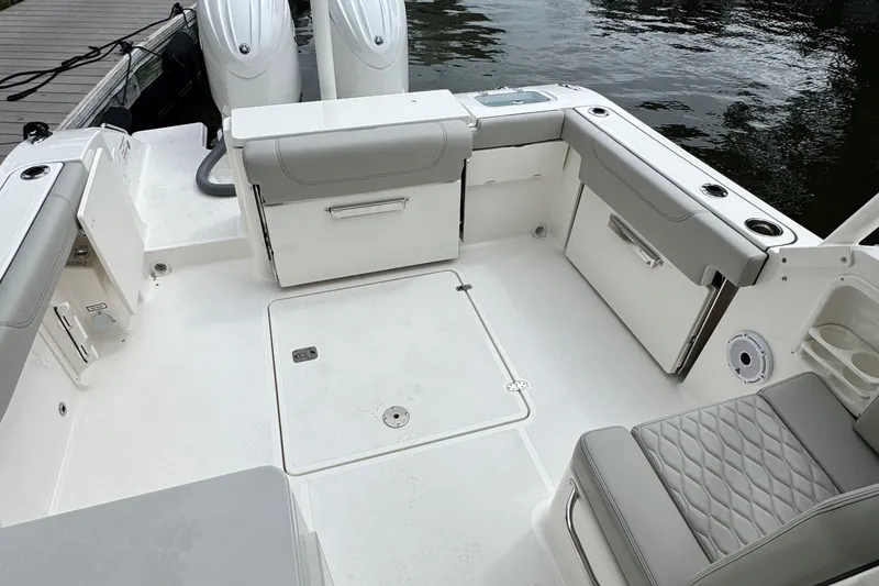 Slide: The Image of 2026 Pursuit DC 266 Dual Console boat interior with seating and storage compartments. - 6