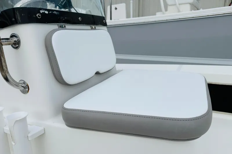Slide: The Image of 2014 Spyder FX17 boat seat with white and gray cushioned design. - 10