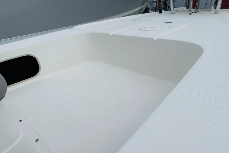 Slide: The Image of 2014 Spyder FX17 boat deck with storage compartment and rod holders. - 11