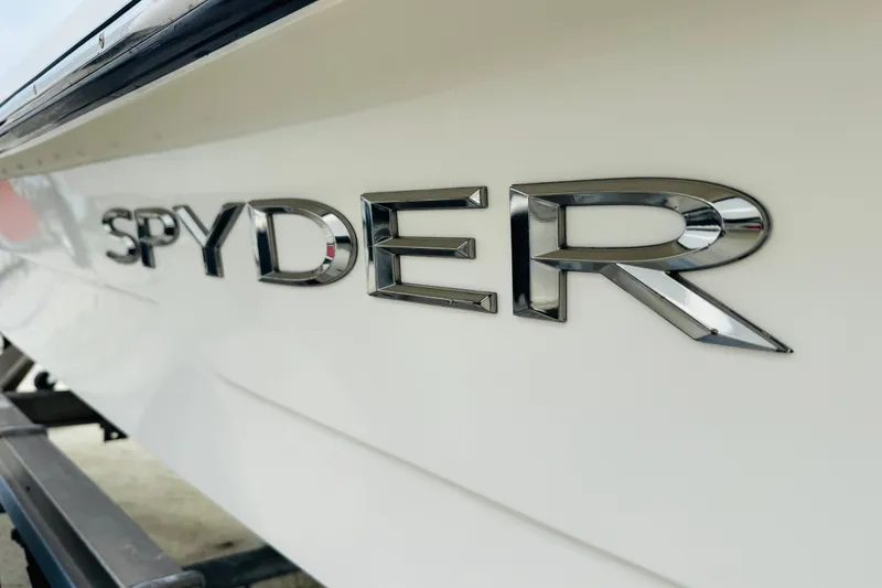 Slide: The Image of 2014 Spyder FX17 boat logo in chrome on white hull. - 4