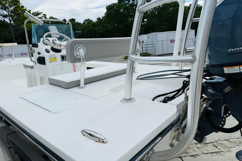 Slide: The Image of 2014 Spyder FX17 boat with steering console and outboard motor, parked on a trailer. - 5