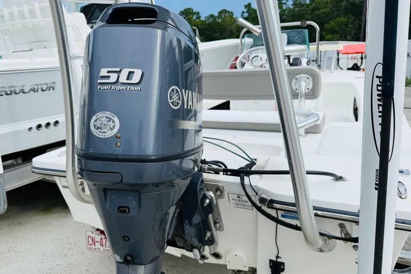 Slide: The Image of 2014 Spyder FX17 boat with Yamaha 50HP fuel injection engine, docked outdoors. - 6