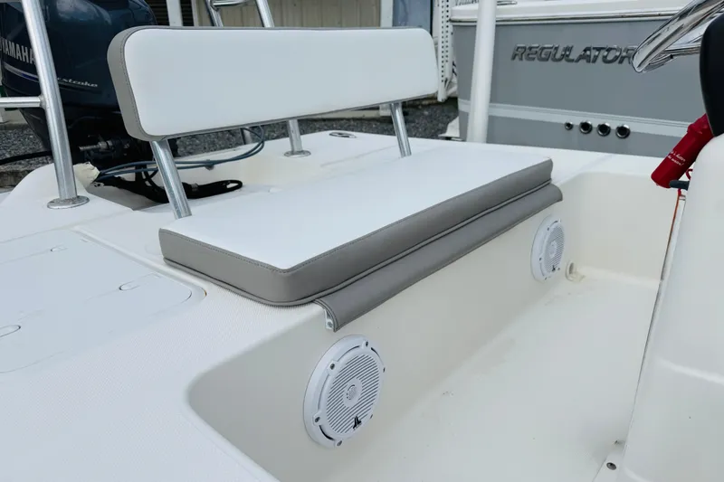 Slide: The Image of 2014 Spyder FX17 boat seating area with white cushions and built-in speakers. - 8