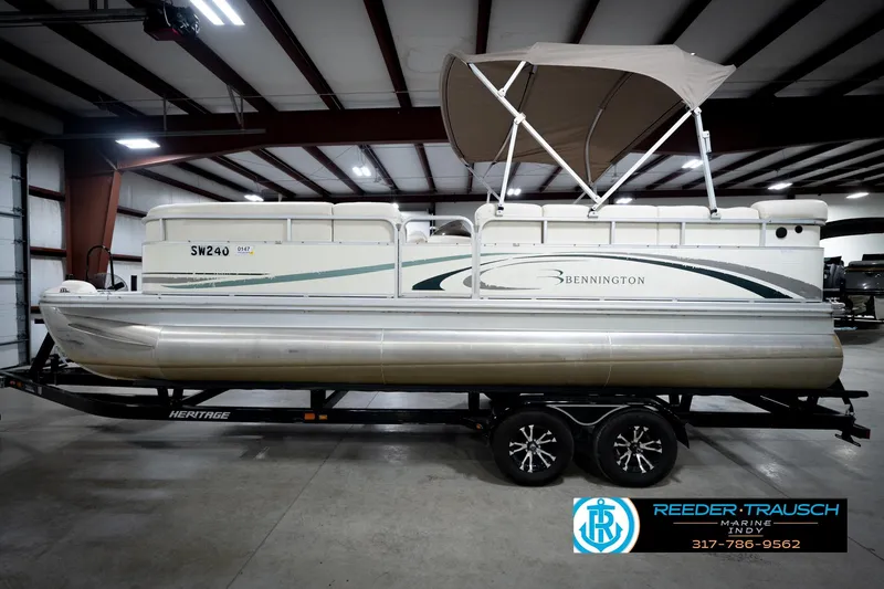 Slide: The Image of 2006 Bennington 2250RL pontoon boat with canopy on trailer in indoor showroom. - 10