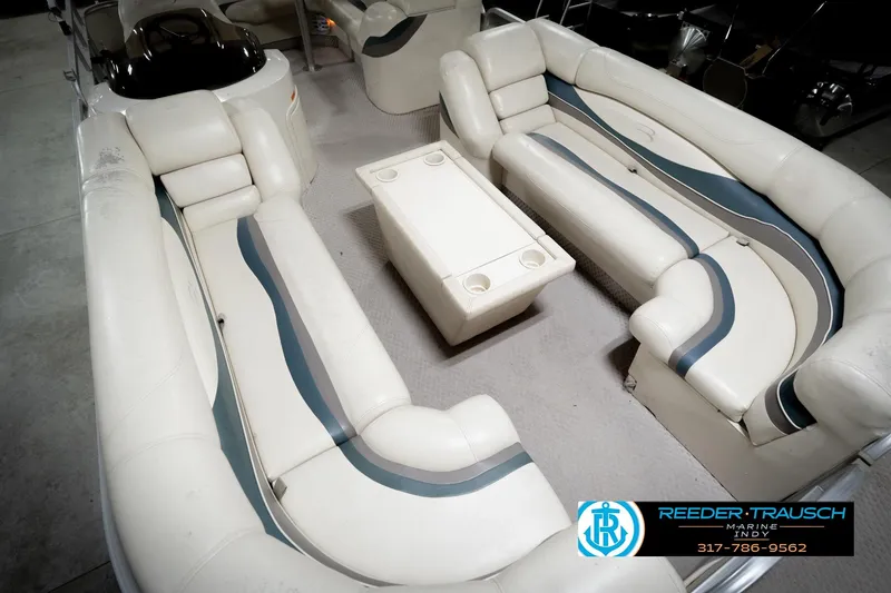 Slide: The Image of 2006 Bennington 2250RL boat interior with white and blue seating arrangement. - 12