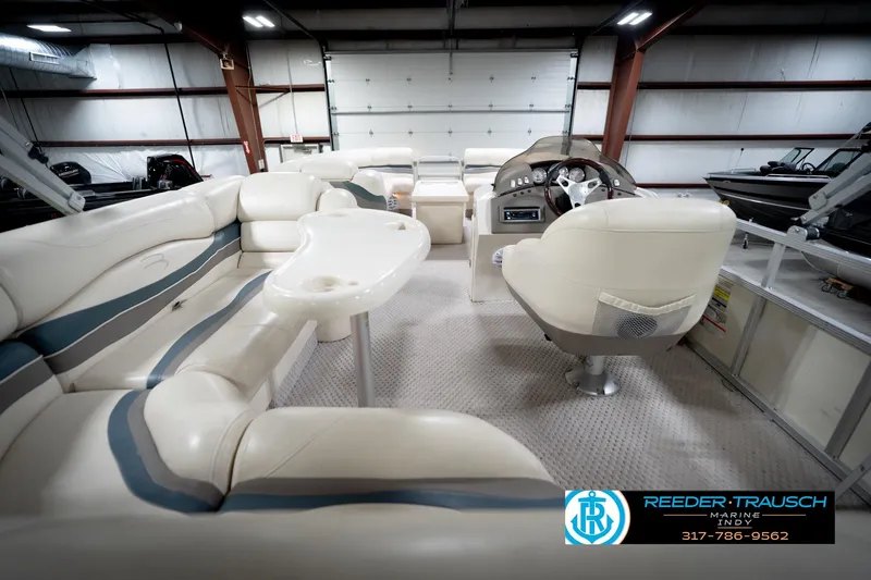 Slide: The Image of Interior of a 2006 Bennington 2250RL pontoon boat with plush seating and steering console. - 18