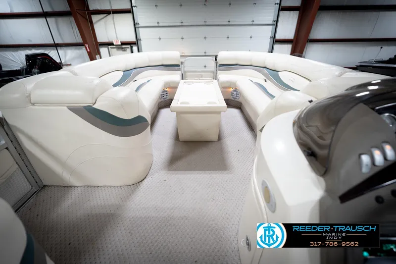 Slide: The Image of 2006 Bennington 2250RL pontoon boat interior with plush seating and central table. - 19