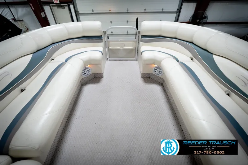 Slide: The Image of 2006 Bennington 2250RL boat interior with white and blue seating, spacious layout. - 21