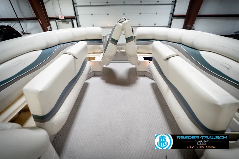 Slide: The Image of Interior of 2006 Bennington 2250RL pontoon boat with white seating and blue accents. - 22
