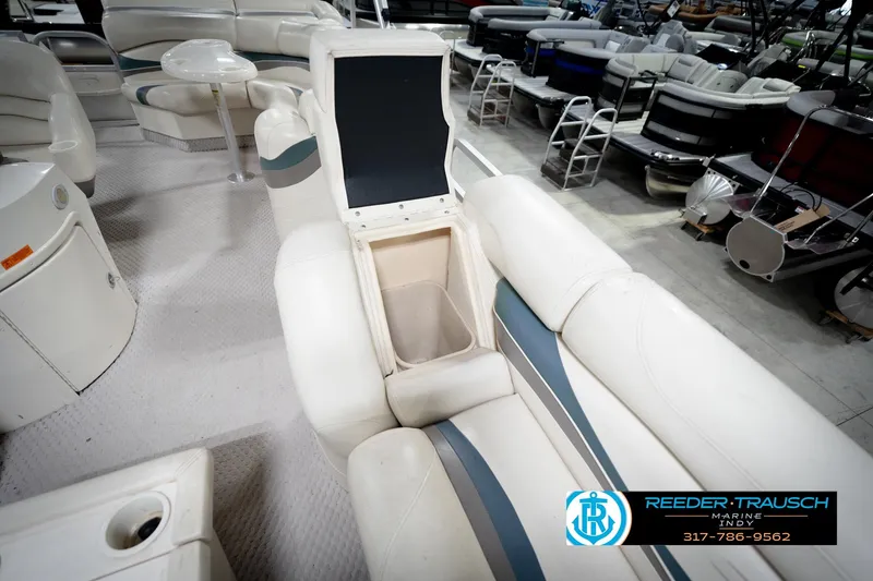 Slide: The Image of 2006 Bennington 2250RL boat interior with open storage compartment and seating. - 24