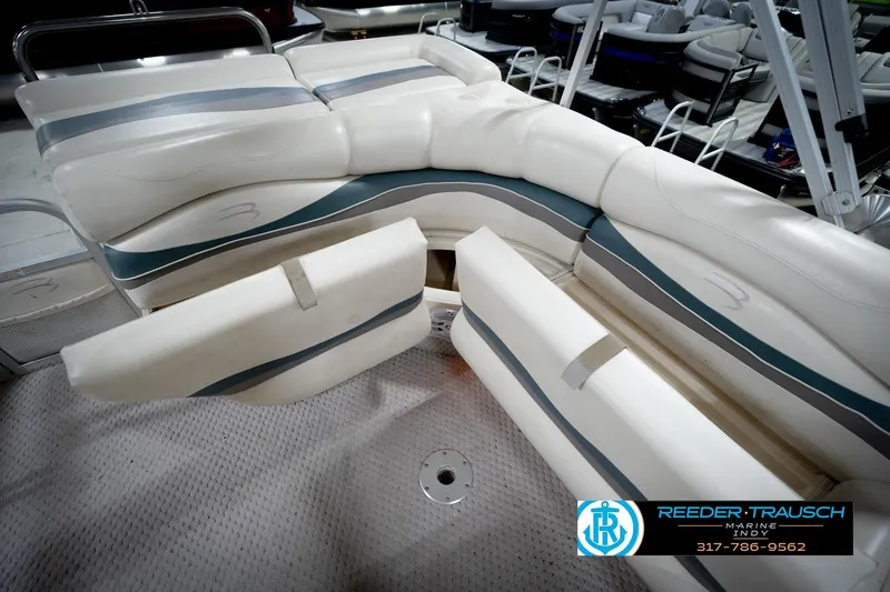 Slide: The Image of 2006 Bennington 2250RL boat interior with white cushioned seating and storage compartments. - 27