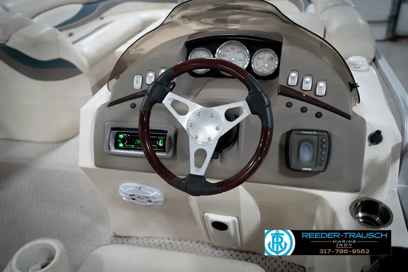 Slide: The Image of 2006 Bennington 2250RL boat dashboard with steering wheel and control panel. - 28
