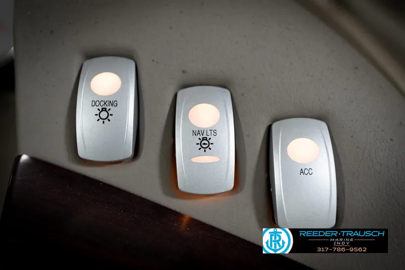 Slide: The Image of Close-up of illuminated switches on a 2006 Bennington 2250RL boat dashboard. - 35