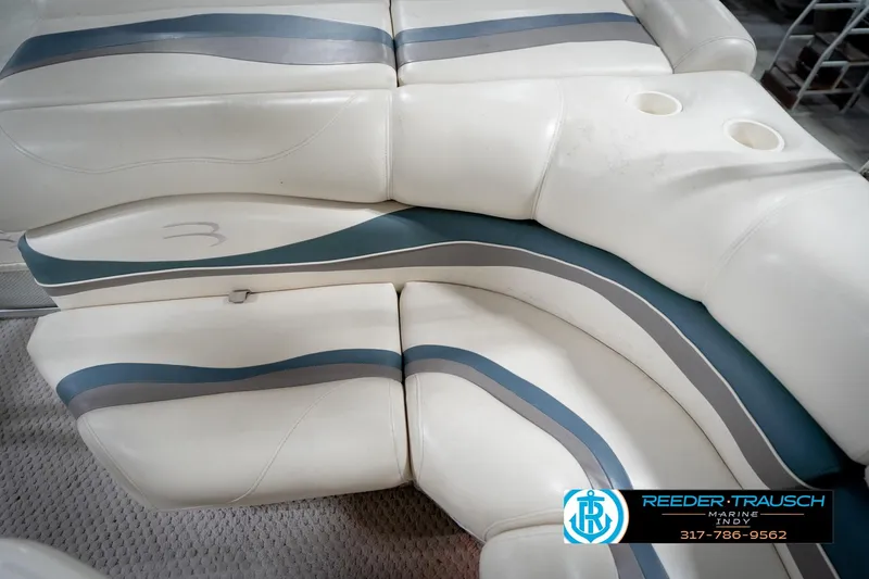 Slide: The Image of 2006 Bennington 2250RL boat interior with white and blue seating, cup holders visible. - 41