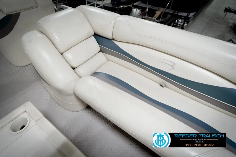 Slide: The Image of 2006 Bennington 2250RL boat interior with white and blue seating, Reeder Trausch Marine logo. - 42