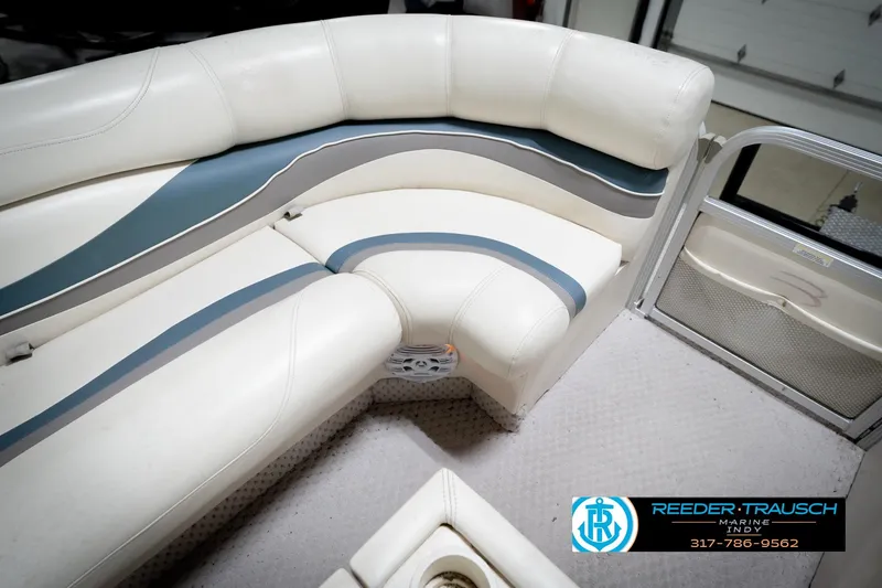 Slide: The Image of 2006 Bennington 2250RL boat interior with white and blue seating, Reeder Trausch Marine logo. - 43