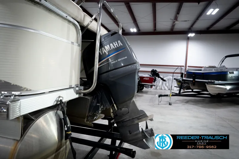 Slide: The Image of 2006 Bennington 2250RL with Yamaha outboard motor in a showroom. - 48